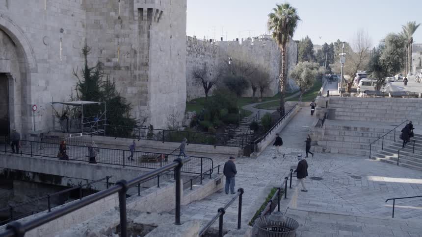 People walk around outside a castle