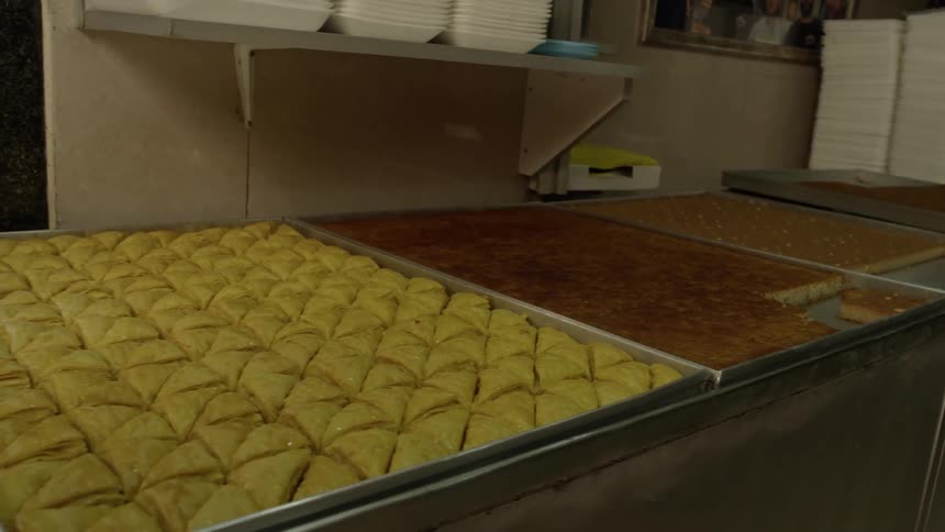 Baked goods sit on large pans in business kitchen