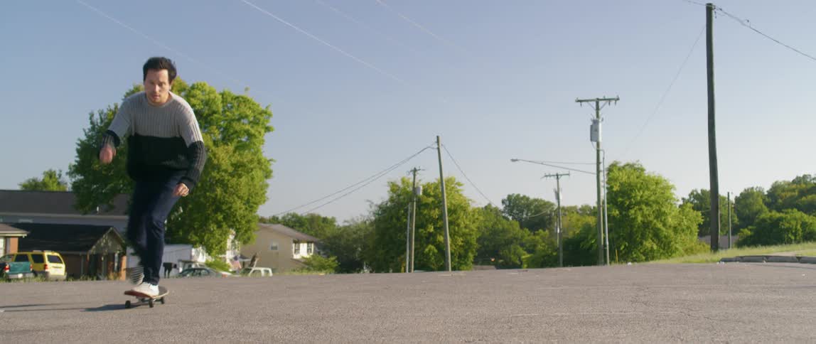 A man riding a skateboard in the street