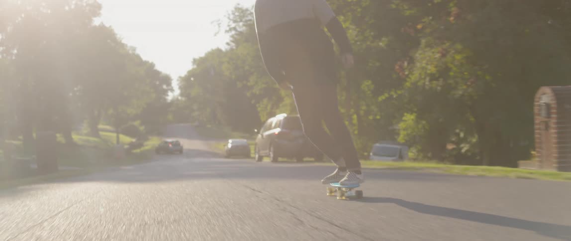 A man riding a skateboard down the street