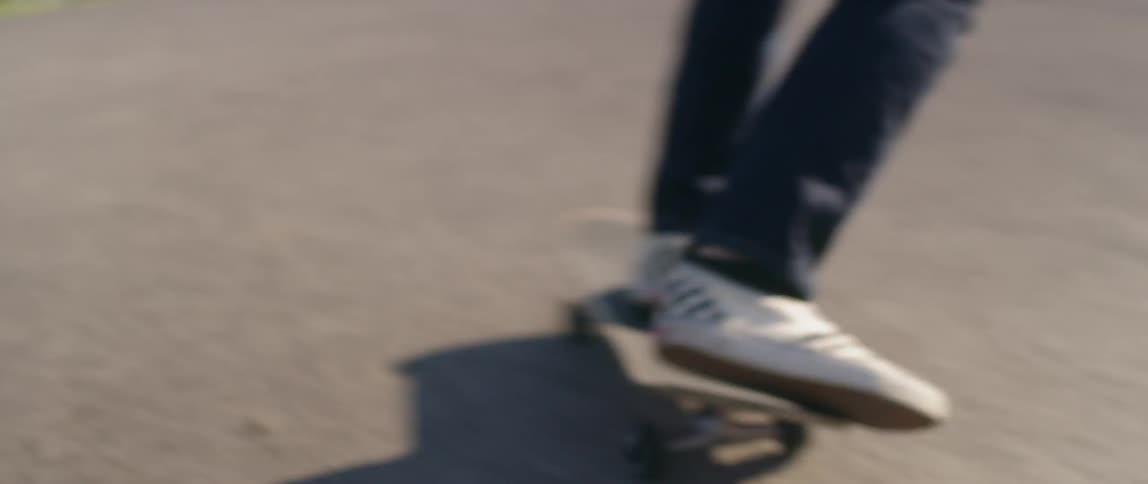 Person with white checkered shoes skateboarding