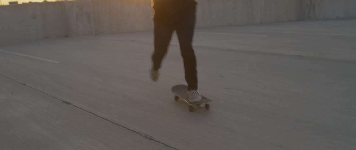 A person riding a skateboard on a rooftop