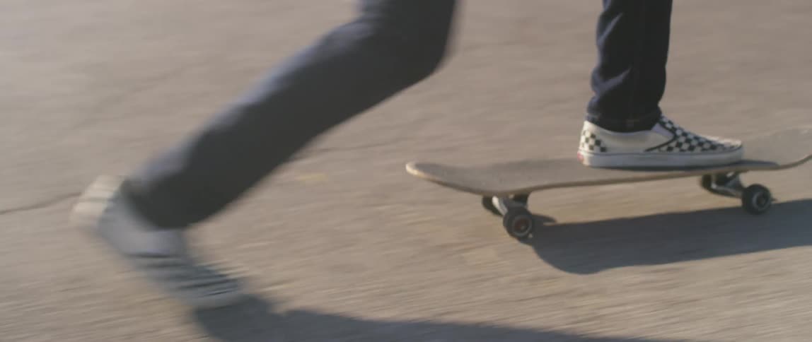 A person skateboards down a street