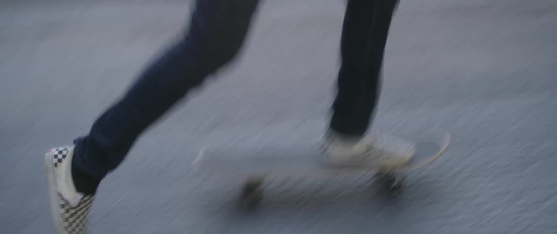 Person kicks a skateboard and then rides away