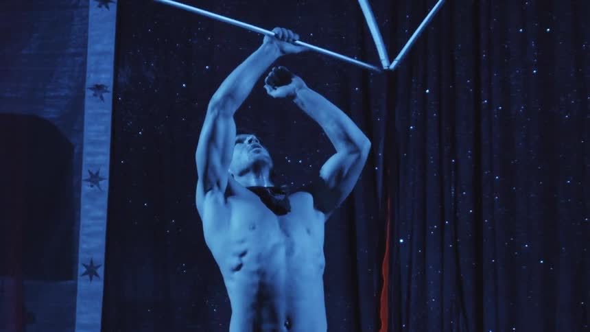 A man twirls some kind of circus apparatus