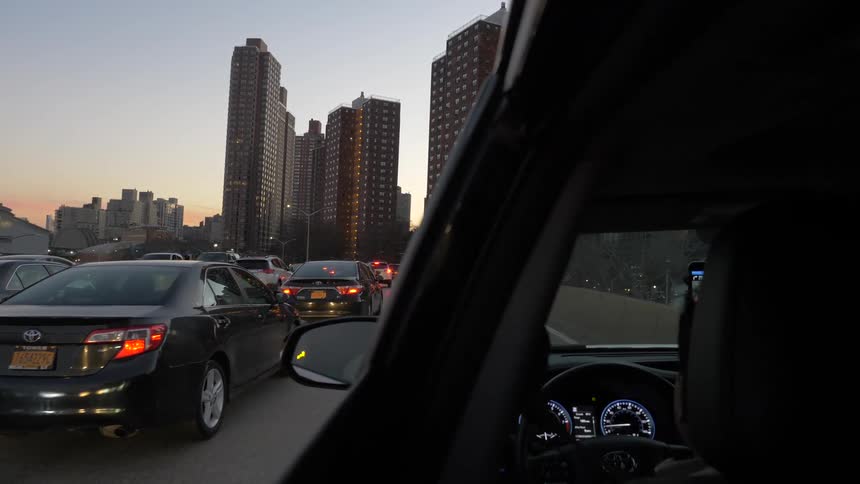 Cars line up on the road heading to the city