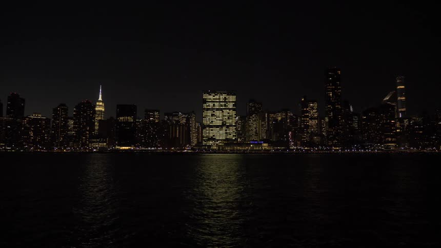 A city skyline at night from across the river