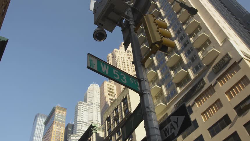 Worms eye view up at city traffic light and street sign