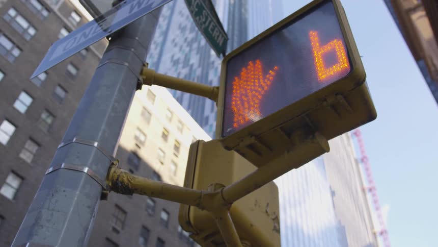 A timer drops at the crosswalk of a light
