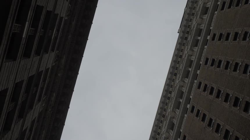 A gloomy and cloudy sky between two downtown buildings