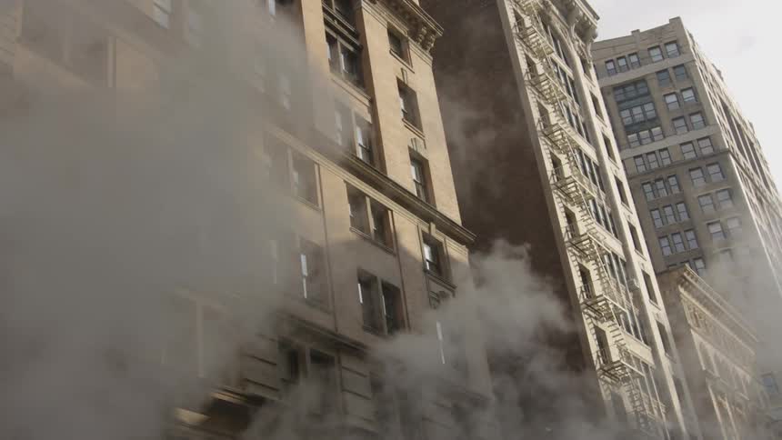 Smoke flowing down a city street