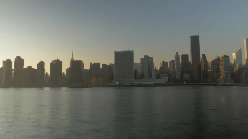 A city skyline at daytime from across the river