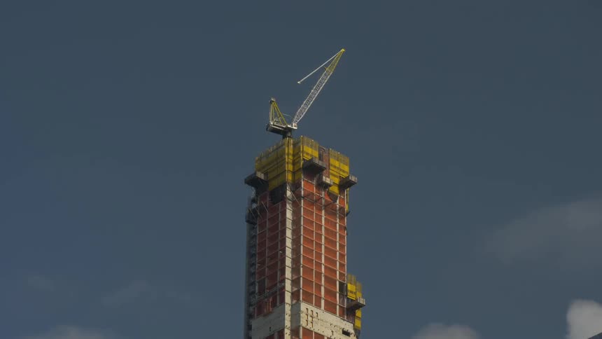 A an elevator moves up and down an under construction building