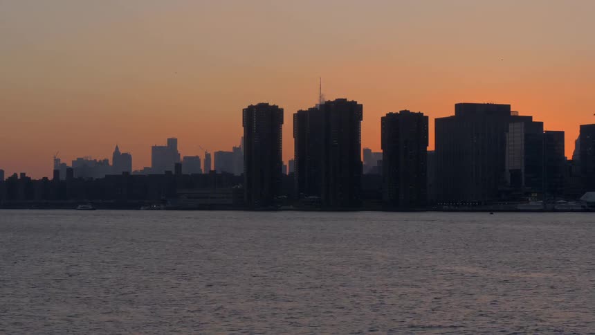 A city skyline at sunset and a free flowing river