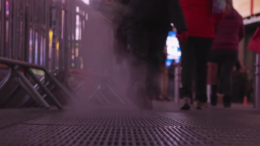 People are walking in a downtown area at night