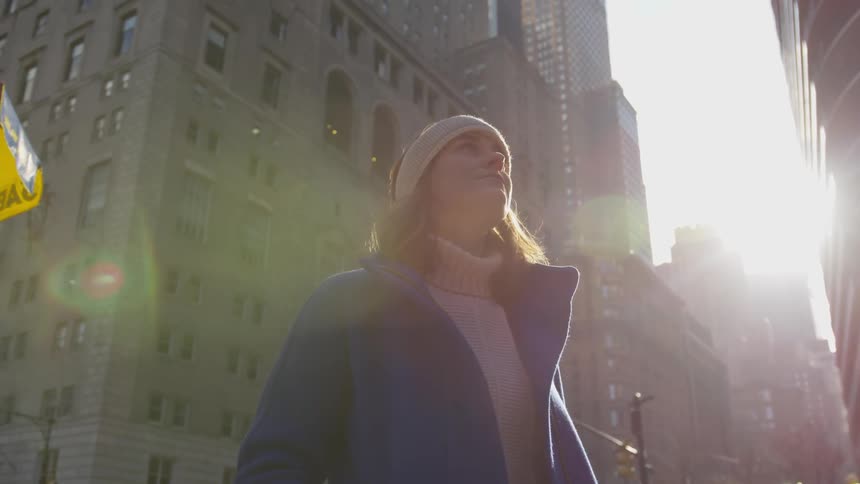 A woman stares up to the building