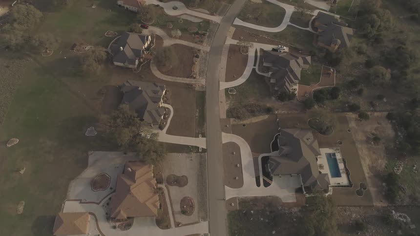 Houses and driveways cover a residential landscape