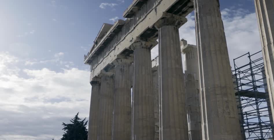 Large stone pillars line a cloudy sky