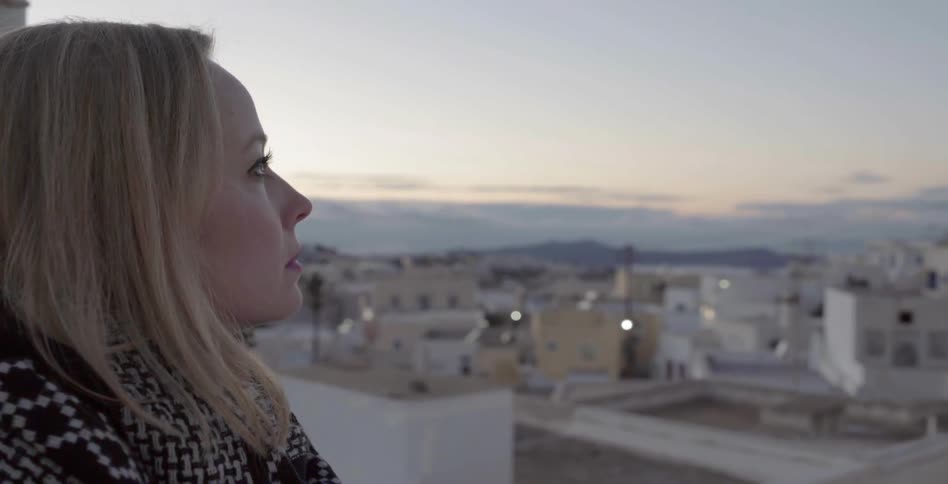 A woman is looking out over the city