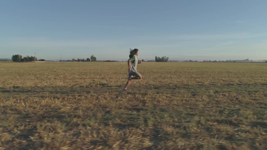 A female running through a field