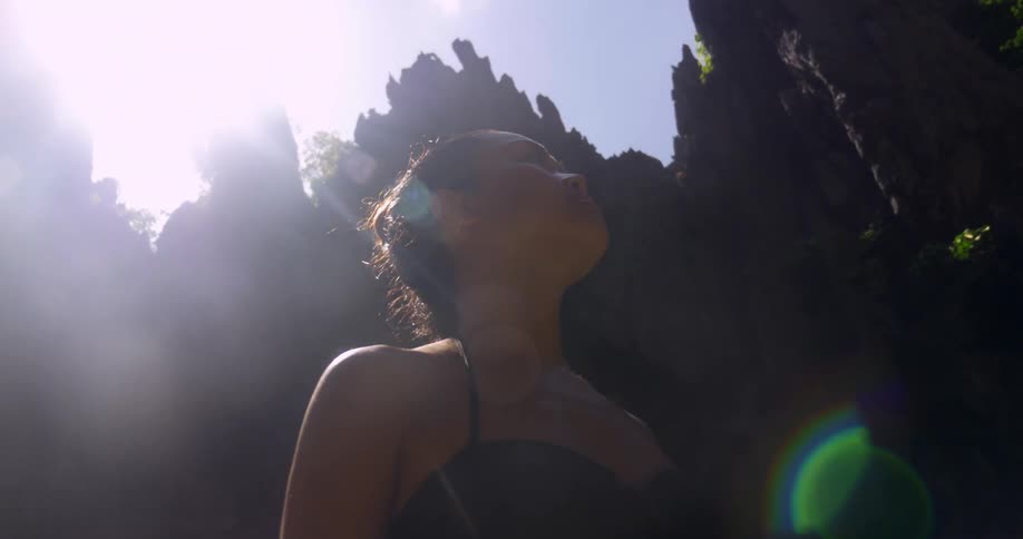 A woman is hiking in the woods