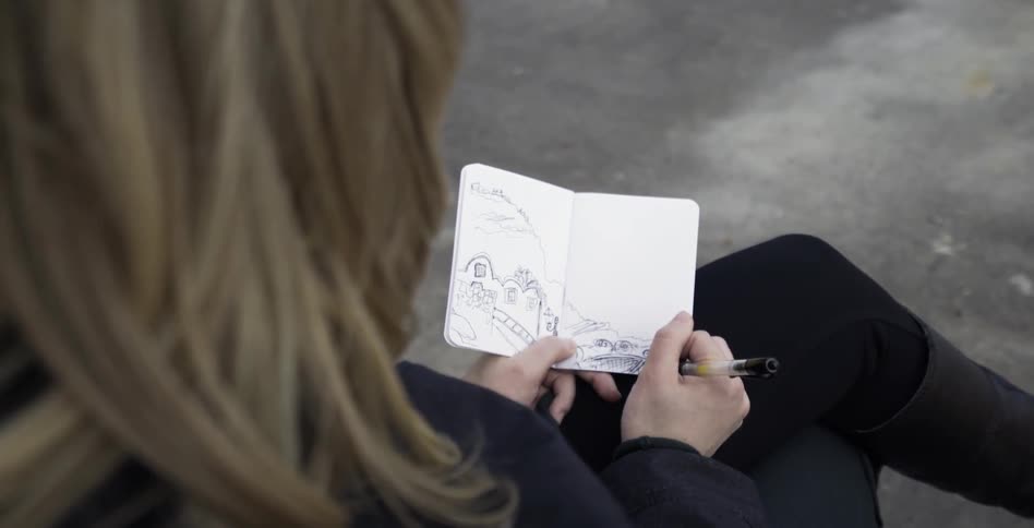 A person drawing with a pen