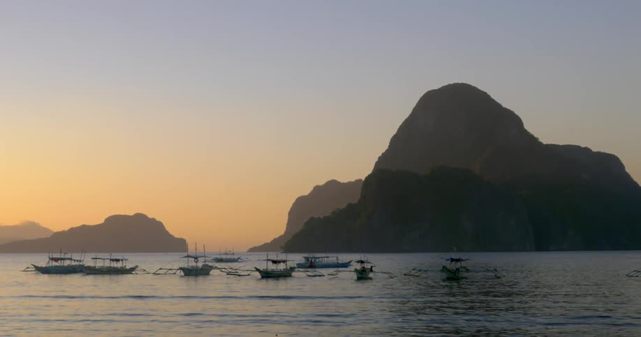 Boats sitting on the water at sunrise