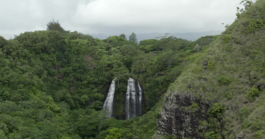 A waterfall cascading over a cliff in the wilderness