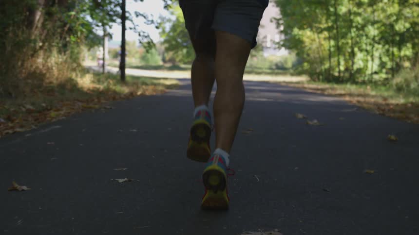 A man running in a park pathway