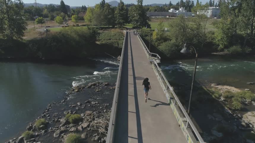 A woman running on a bridge