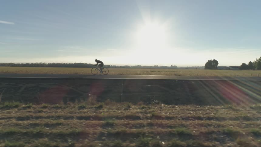 A person riding a bike on a deserted road
