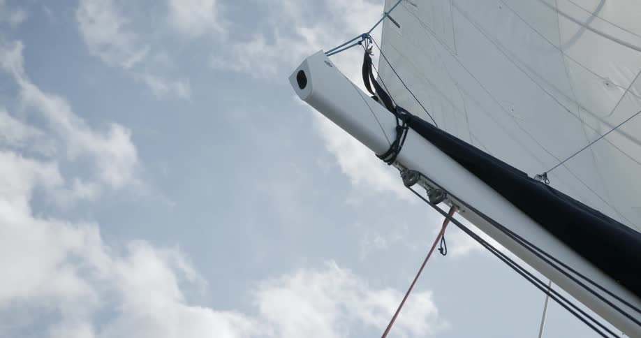 A boat sail extends towards the sky