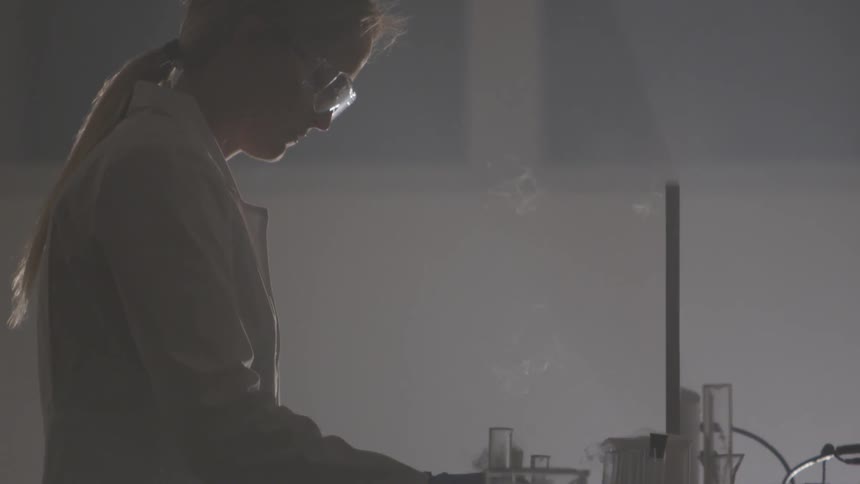 A woman mixes a solution in a lab