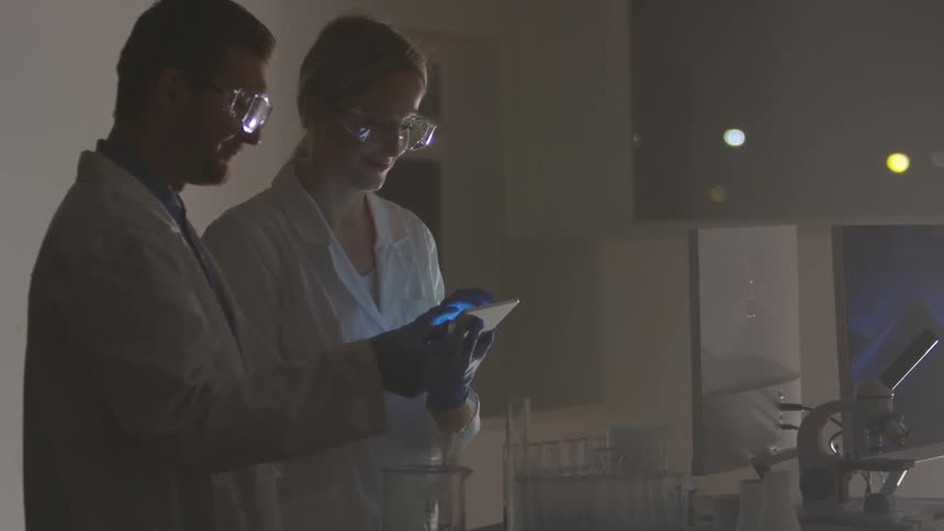 A man and a woman work in a lab