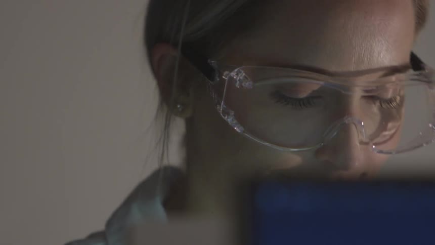 A woman is wearing goggles and looking at something