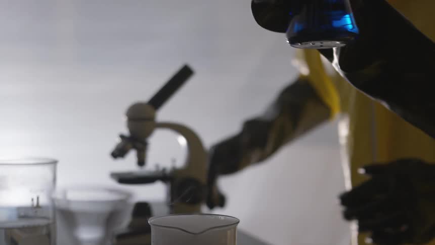 A scientist mixing a liquid in a beaker