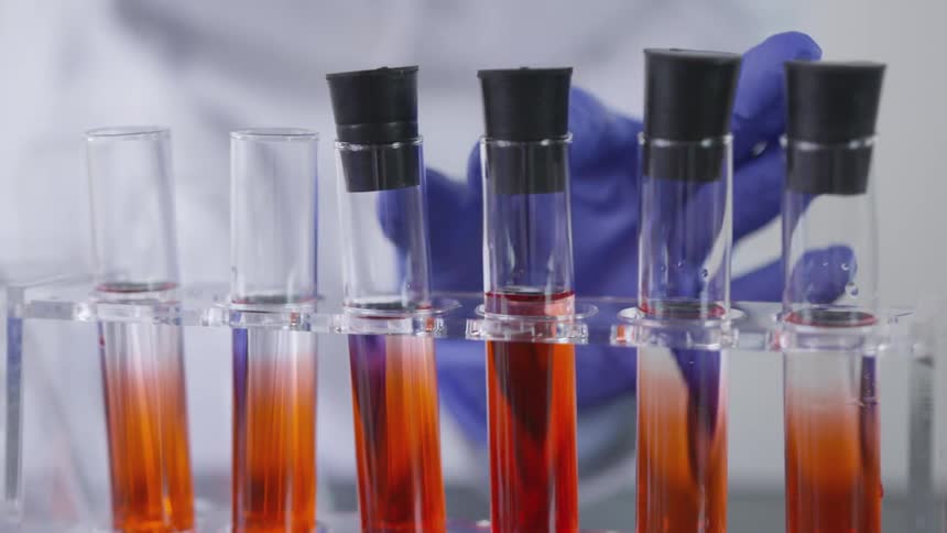 Person putting lid on test tube