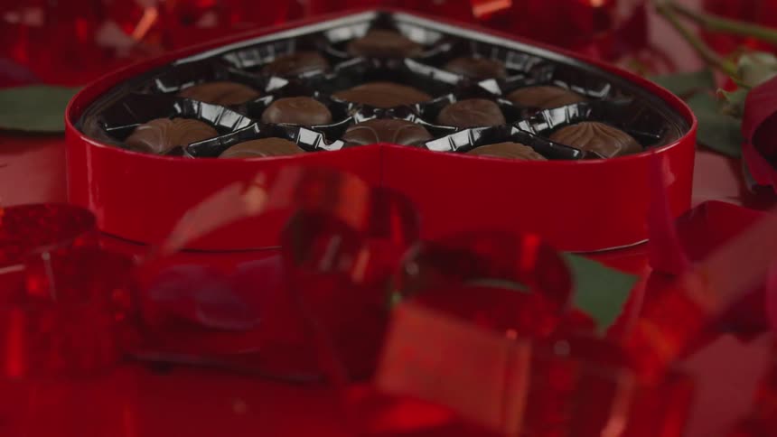 A person is opening a box of chocolates