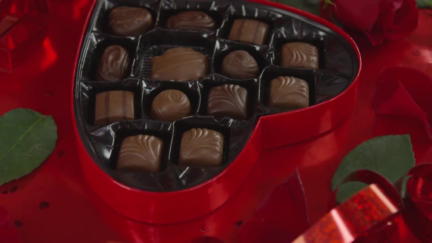 Person opening a box of chocolate