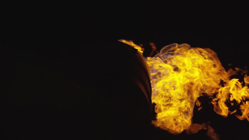 A fire burns in darkness