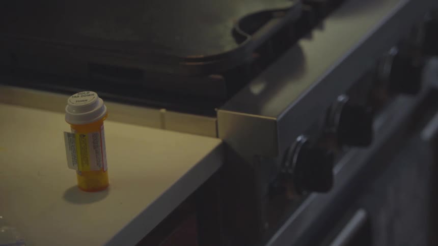 Medicine bottle on counter next to stove