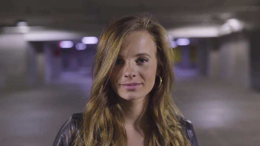 A woman smiles at the camera