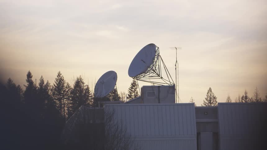 Two antennas on the roof of the house at sunset