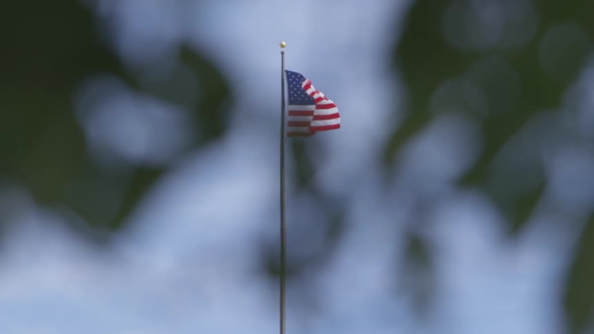 American flag waving on a tall flagpole