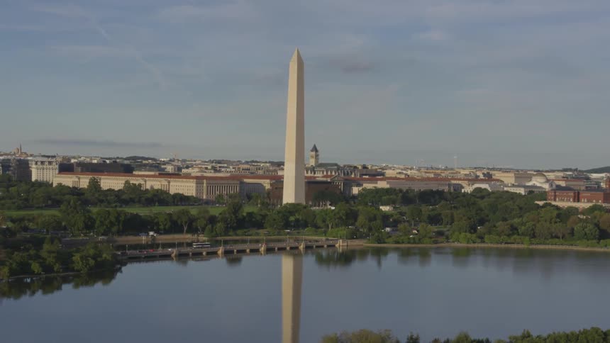 A downtown city is displayed by a body of water