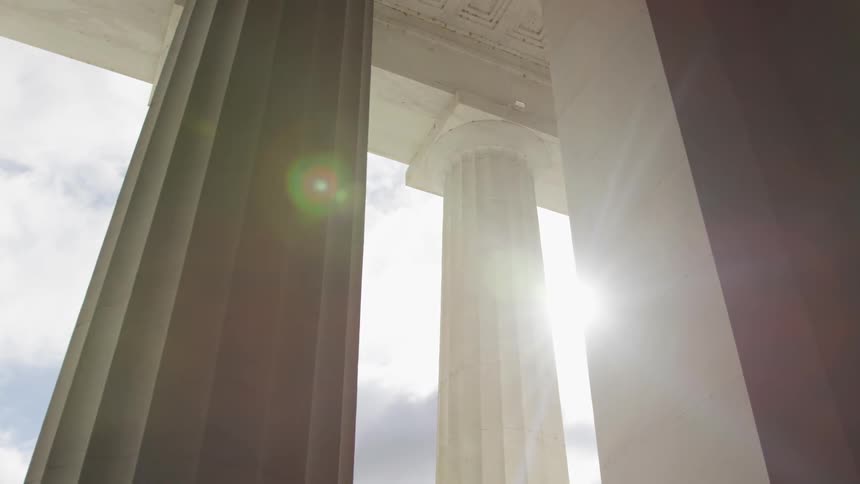 Sun shining through pillars of government building