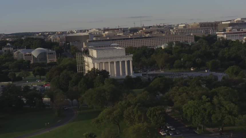 Government buildings are surrounded by lush trees in the city