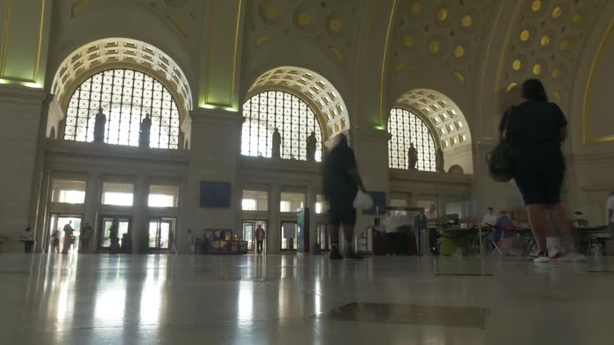 People walk around inside a large building