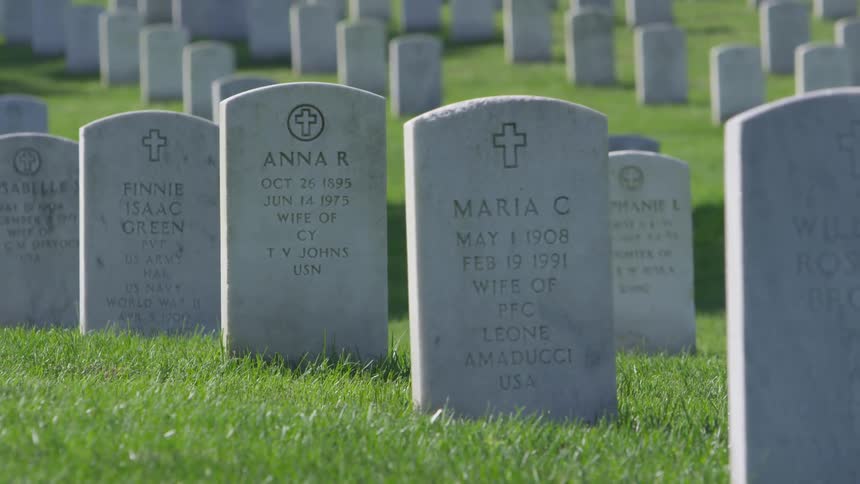 Many headstones share the dates of military men and women