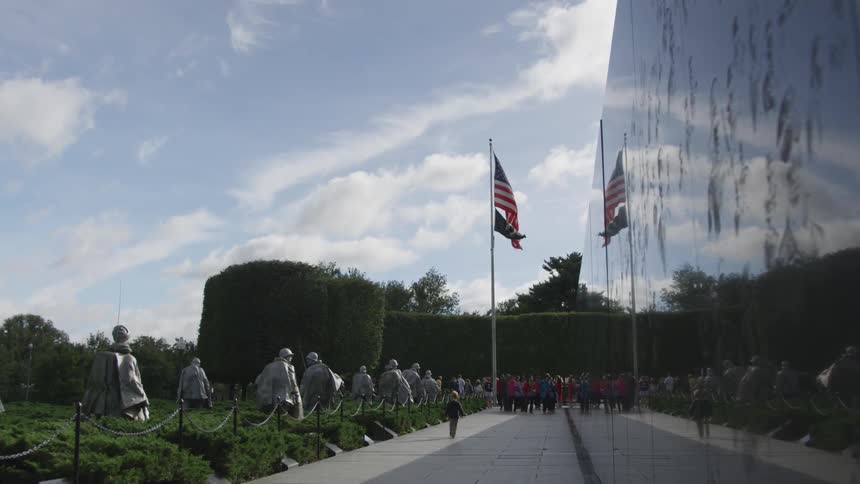 People walking in front of vietnam war memorial